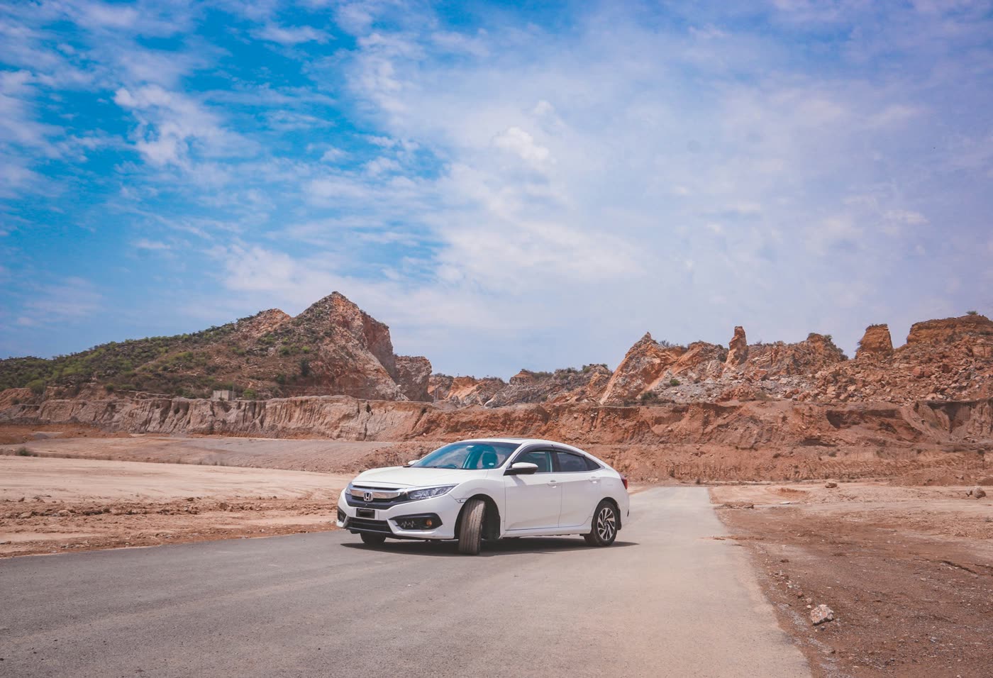 White Honda Civic parked on open ground